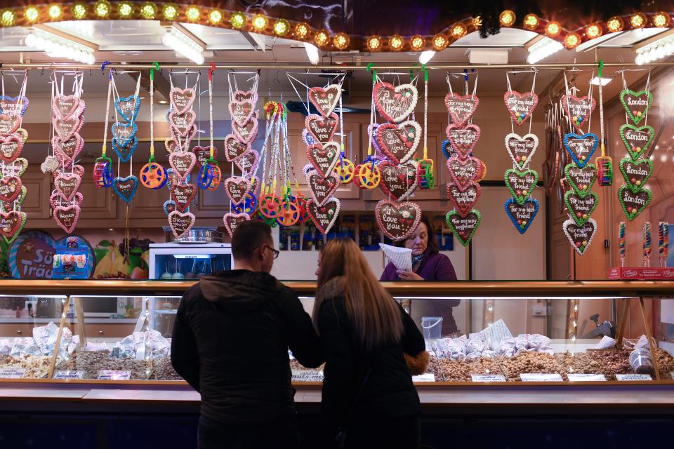 Visitors at a snack stall at Winter Wonderland in Hyde Park, London (PA)