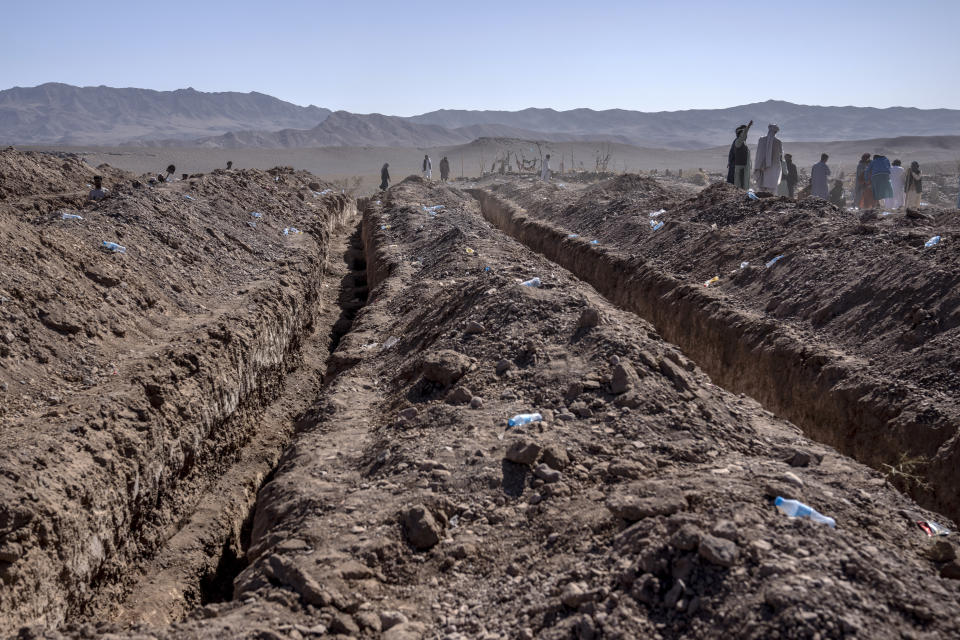 Afghans dig a trench for a common grave for their relatives killed in an earthquake to a burial site in Zenda Jan district in Herat province, western of Afghanistan, Monday, Oct. 9, 2023. Saturday's deadly earthquake killed and injured thousands when it leveled an untold number of homes in Herat province. (AP Photo/Ebrahim Noroozi)