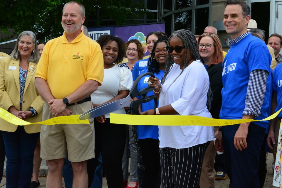 Heart of Missouri United Way Board Chair Eryca Neville cuts the ribbon Friday on the organization's Give 5 program at Missouri Employers Mutual Insurance in Columbia, which is serving as home base for the program.