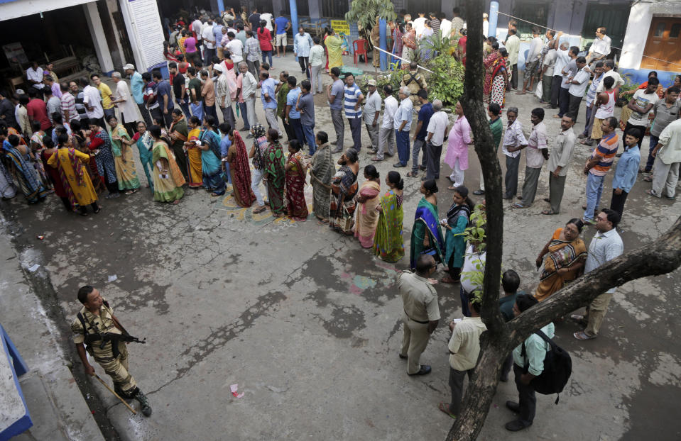 Indian voters stand in queues to cast their votes at Baksara in Howrah, India, Monday, May 6, 2019. With 900 million of India's 1.3 billion people registered to vote, the Indian national election is the world's largest democratic exercise. (AP Photo/Bikas Das)