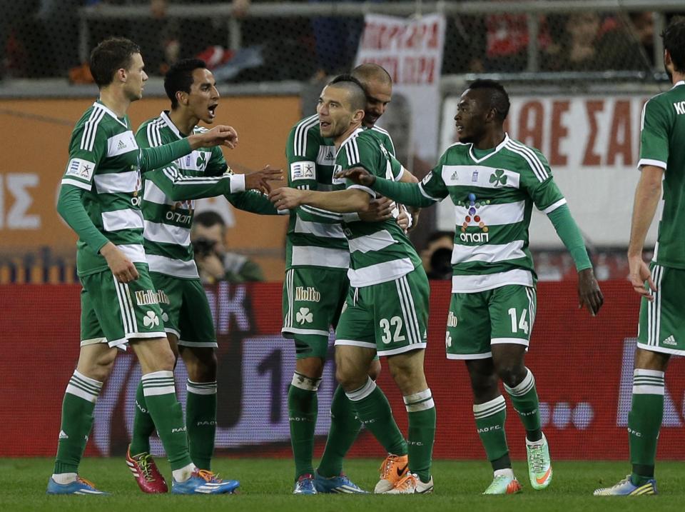 Panathinaikos' Danijel Pranjic of Croatia, 32, celebrates with his teammates after scoring the opening goal against Olympiakos during a Greek League soccer match at Georgios Karaiskakis stadium, in Piraeus port, near Athens, on Sunday, March 2, 2014. (AP Photo/Thanassis Stavrakis)