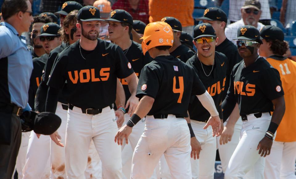 May 29, 2022; Hoover, AL, USA;  Teammates greet Tennessee outfielder Seth Stephenson (4) after he scored against Florida in the SEC Tournament Championship game at the Hoover Met in Hoover, Ala., Saturday. Mandatory Credit: Gary Cosby Jr.-The Tuscaloosa News