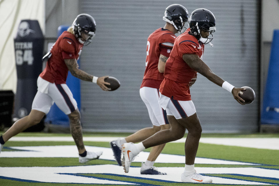 Houston Texans quarterback Deshaun Watson (4) works on handoff drills with the quarterbacks group during an NFL training camp football practice Friday, Aug. 14, 2020, at The Houston Methodist Training Center in Houston. (Brett Coomer/Houston Chronicle via AP)