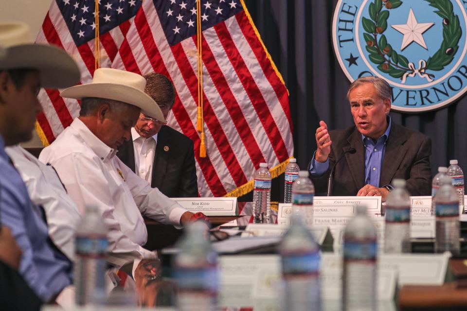 “One thing that we know for a fact, and that is there are maybe as many as 100,000 migrants who are across the border waiting to cross into the state of Texas,” Gov. Greg Abbott, seen at a border security briefing at the Capitol in July, said Monday.
