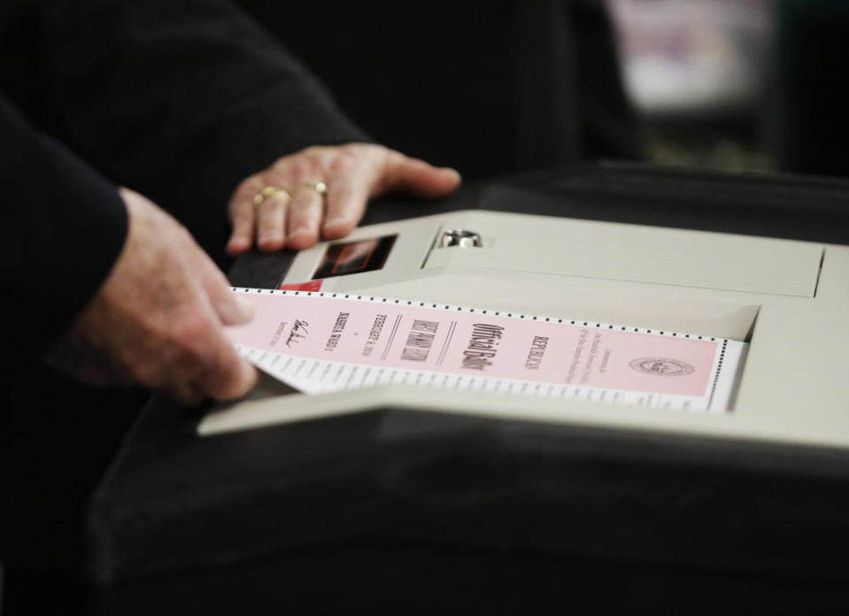A ballot is entered into a machine in Nashua