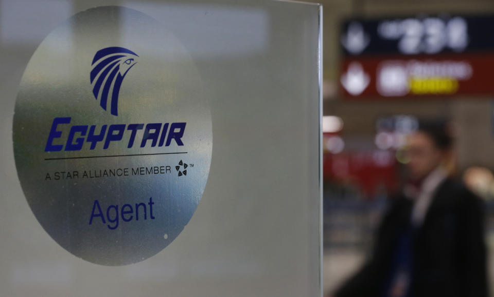 A man passes the EgyptAir desk at Charles de Gaulle Airport after an EgyptAir flight disappeared from radar during its flight from Paris to Cairo, in Paris, France, May 19, 2016. (Reuters/Christian Hartmann)