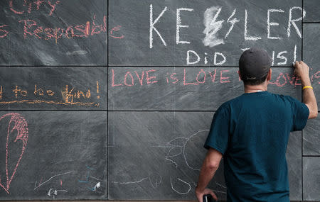 Russ Naranjo of Charlottesville writes a message about "Unite the Right" rally organizer Jason Kessler and the rally on the city's "Free Speech Wall" along the downtown mall in Charlottesville, Virginia, August 14, 2017. REUTERS/Justin Ide