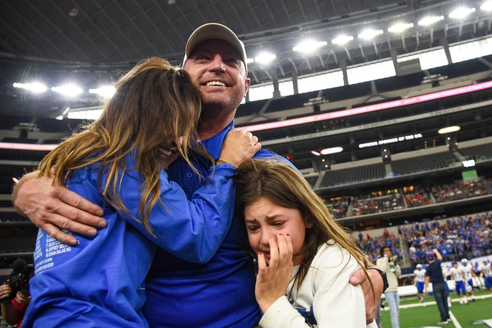 Stratford Head Coach Matt Lovorn embraces his wife Kelsey Lovorn, and his daughter, Laykin, 6, following the Texas state high school football Conference 2A Division II championship game between Stratford and Falls City at AT&T Stadium in Arlington, Texas on Thursday, December 16, 2021. Stratford won the game by a final of 39-27. (Emil Lippe for the Amarillo Globe-News)