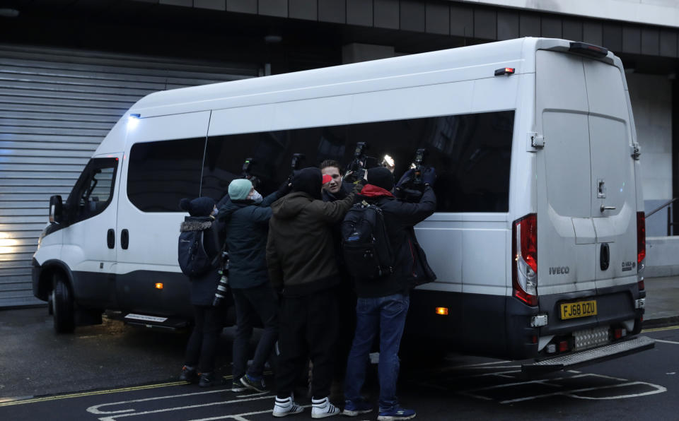 Members of the media film and photograph the prison van with Julian Assange inside as it arrives at Westminster Magistrates Court for his Bail hearing in London, Wednesday, Jan. 6, 2021. On Monday Judge Vanessa Baraitser ruled that Julian Assange cannot be extradited to the US. because of concerns about his mental health. Assange had been charged under the US's 1917 Espionage Act for "unlawfully obtaining and disclosing classified documents related to the national defence". Assange remains in custody, the US. has 14 days to appeal against the ruling. (AP Photo/Matt Dunham)