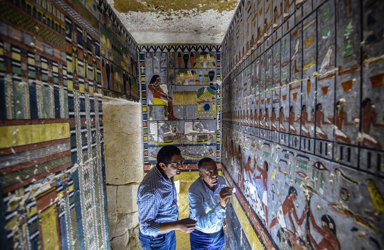 Mohamed Megahed (L), head of the Egyptian mission which discovered the tomb of the ancient Egyptian nobleman ‘Khewi’, inspects the tomb’s walls inside at the Saqqara necropolis (Mohamed el-Shahed/AFP/Getty)