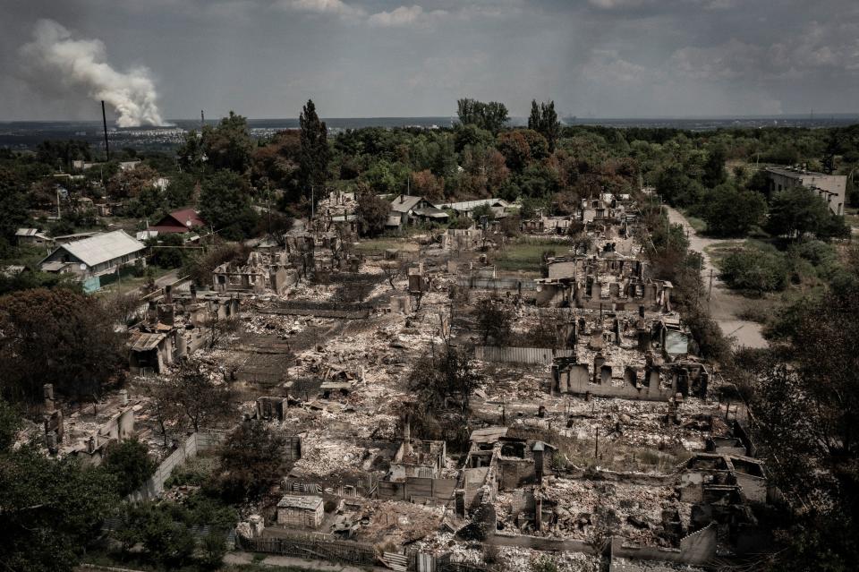 An aerial view shows destroyed houses after strike in the town of Pryvillya at the eastern Ukrainian region of Donbas on 14 June (AFP via Getty Images)