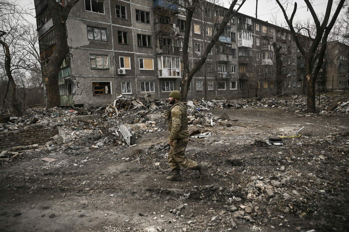  A Ukranian serviceman walks among debris after a strike in the town of Chasiv Yar, in the region of Donbas on March 16  (AFP via Getty Images)