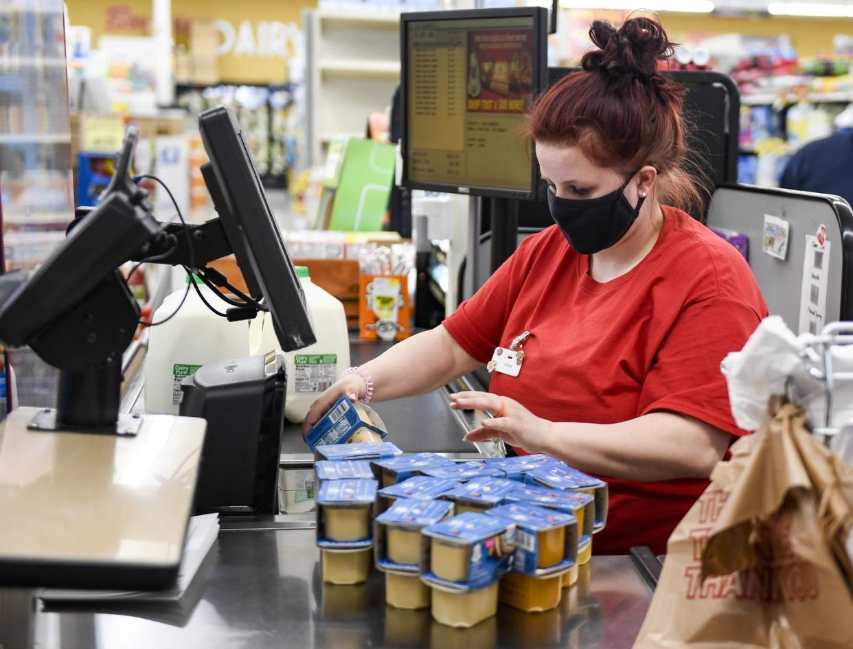 <span class="caption">Many grocery store workers have experienced high rates of anxiety and depression during the pandemic.</span> <span class="attribution"><a class="link " href="https://www.gettyimages.com/detail/news-photo/boyers-cashier-kathryn-laudermilch-scans-a-customers-news-photo/1311680638?adppopup=true" rel="nofollow noopener" target="_blank" data-ylk="slk:Ben Hasty/MediaNews Group/Reading Eagle via Getty Images;elm:context_link;itc:0;sec:content-canvas">Ben Hasty/MediaNews Group/Reading Eagle via Getty Images</a></span>