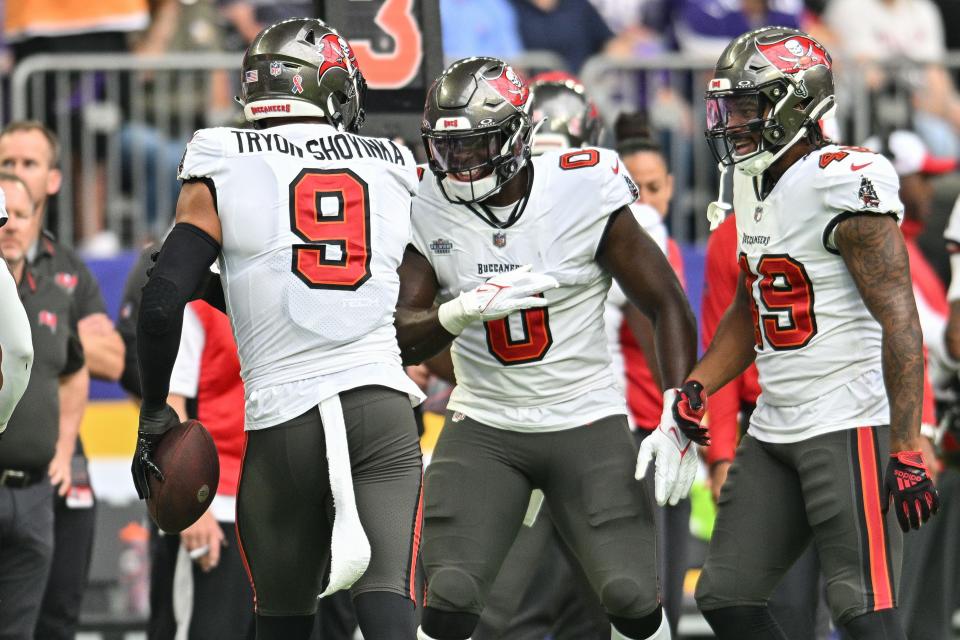 Sep 10, 2023; Minneapolis, Minnesota, USA; Tampa Bay Buccaneers linebacker Joe Tryon-Shoyinka (9) and linebacker Yaya Diaby (0) and linebacker Cam Gill (49) react during the game against the Minnesota Vikings at U.S. Bank Stadium. Mandatory Credit: Jeffrey Becker-USA TODAY Sports