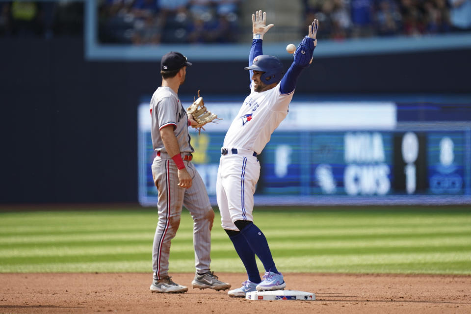 Toronto Blue Jays' George Springer (4) celebrates after stealing a base during the fifth inning of a baseball game against the Minnesota Twins in Toronto, Saturday, June 10, 2023. (Arlyn McAdorey/The Canadian Press via AP)