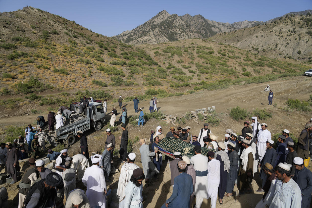 Afghans carry a relative killed in an earthquake to a burial site l in Gayan village, in Paktika province, Afghanistan, Thursday, June 23, 2022. A powerful earthquake struck a rugged, mountainous region of eastern Afghanistan early Wednesday, flattening stone and mud-brick homes in the country's deadliest quake in two decades, the state-run news agency reported. (AP Photo/Ebrahim Nooroozi)