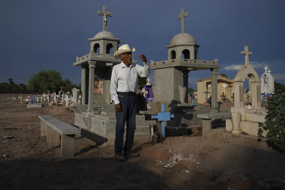 Guillermo Rojo, the father of slain water-defense leader Tomás, prays next to his tomb, decorated with a blue cross, at the cemetery in Potam, Mexico, Tuesday, Sept. 27, 2022. Rojo recalls his son as “iron-willed ever since he was a young boy.” “He didn't forget where he was from, who his ancestors were, and that may be what led him to become a social activist.” (AP Photo/Fernando Llano)