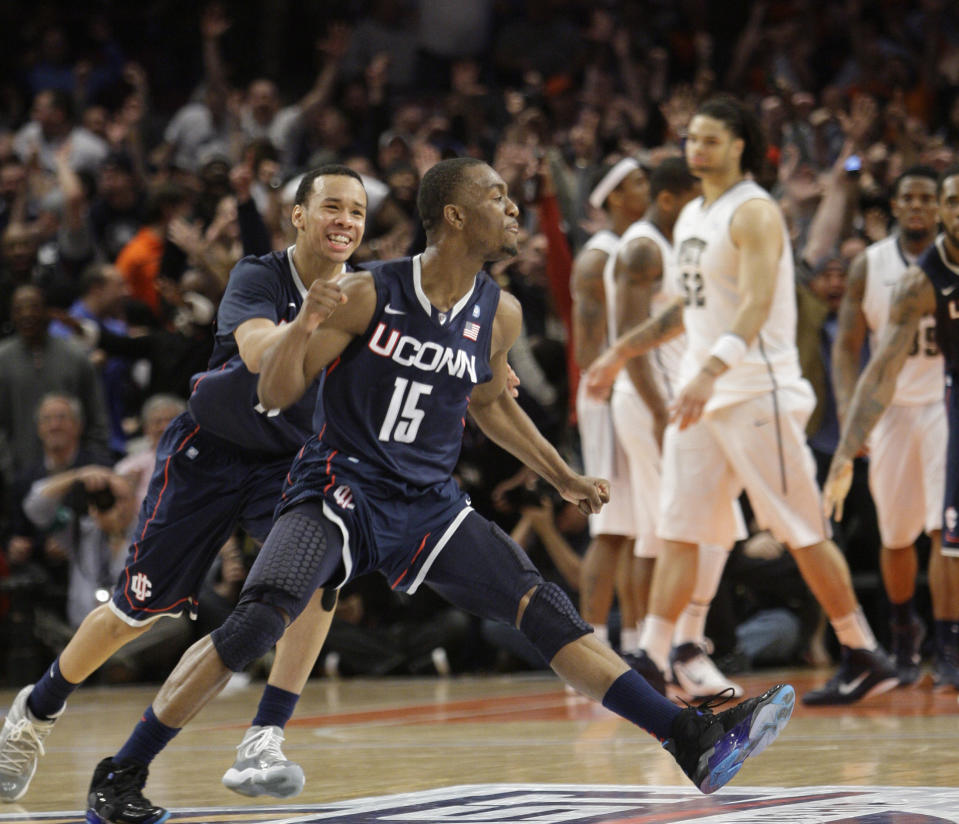 FILE - Connecticut's Kemba Walker (15) celebrates scoring the winning goal with teammate Shabazz Napier, in the final seconds of the second half of an NCAA college basketball game against Pittsburgh in the Big East Championship at Madison Square Garden in New York, in this Thursday, March 10, 2011, file photo. Connecticut defeated Pittsburgh 76-74. The New York Knicks have been looking long for a point guard and didn't have to search too far for their new one. Kemba Walker is from New York and is coming back to the Madison Square Garden court where he's had plenty of success already. (AP Photo/Mary Altaffer, File)