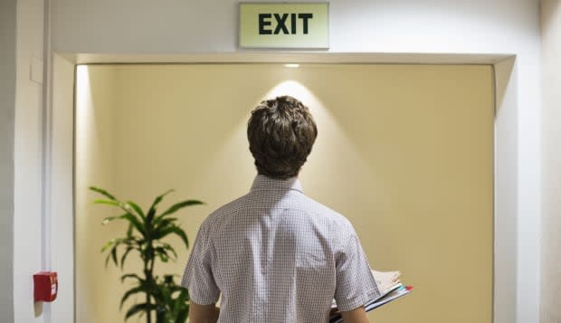 Businessman examining ëexití sign in office