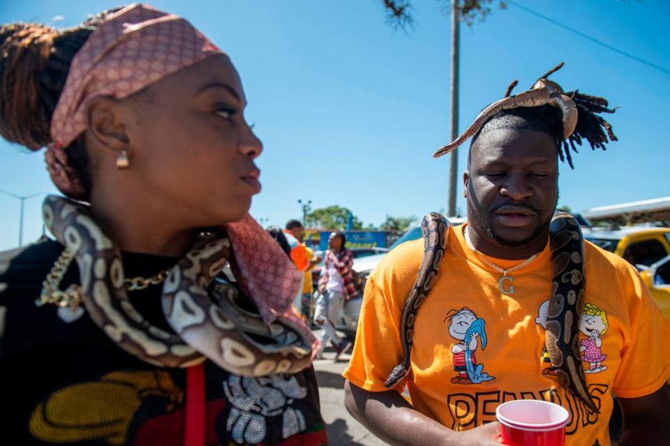 Tiffany Ellis, left, and CJ walk around with their snakes Striker, Key and Cody during Black Spring Break in Biloxi on Saturday, April 9, 2022.