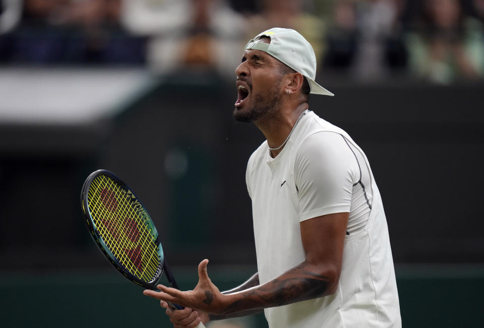 Australia's Nick Kyrgios reacts during his third round men's singles match against Greece's Stefanos Tsitsipas on day six of the Wimbledon tennis championships in London, Saturday, July 2, 2022. (AP Photo/Kirsty Wigglesworth)