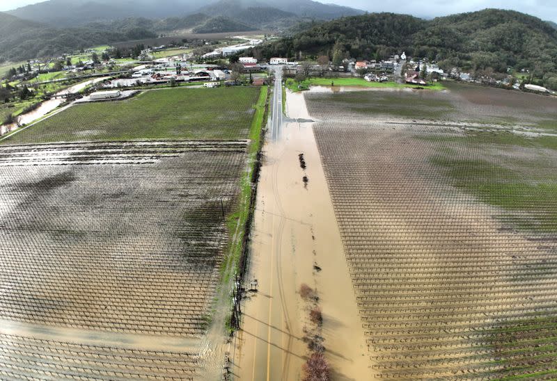 Floodwaters cover farmland and Highway 175 following a chain of winter storms in Hopland