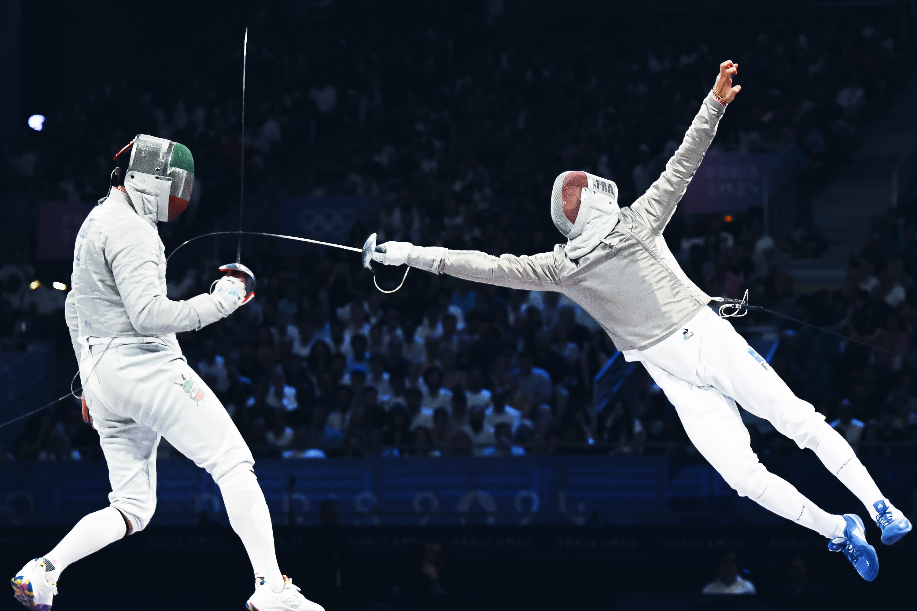 Iran's Mohammad Rahbari Koyakhi (L) competes against France's Sebastien Patrice in the men's sabre team bronze medal bout between Iran and France during the Paris 2024 Olympic Games at the Grand Palais in Paris, on July 31, 2024.  (Photo by FABRICE COFFRINI/AFP via Getty Images)
