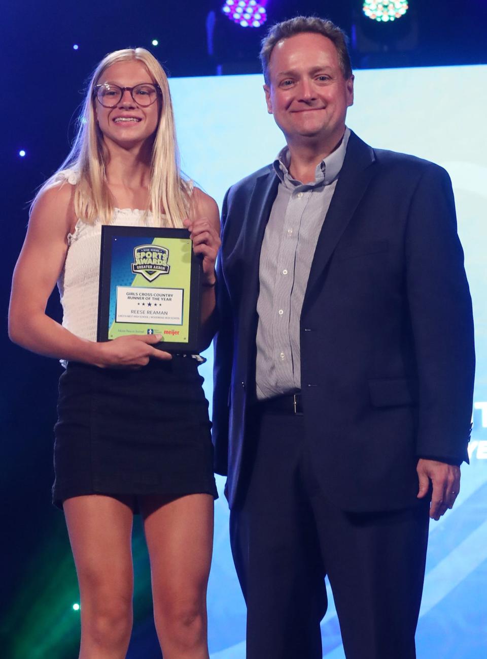 Woodridge High's Reese Reaman Greater Akron Girls Cross Country Player of the Year with Michael Shearer Akron Beacon Journal editor at the High School Sports All-Star Awards at the Civic Theatre in Akron on Friday.