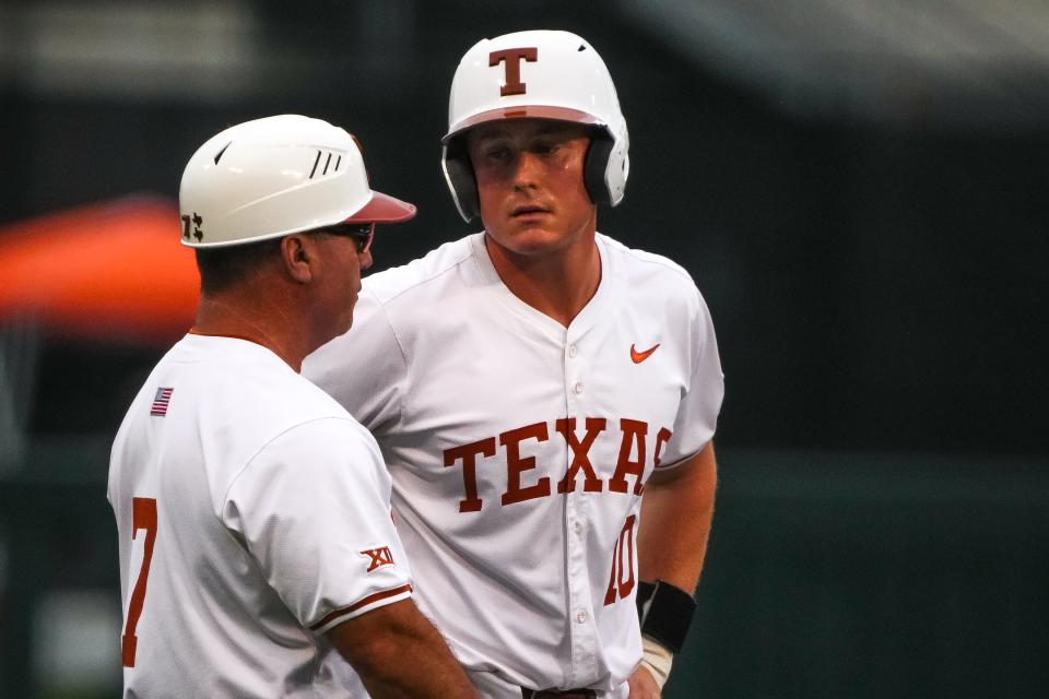 Texas Longhorns assistant coach Steve Rodriguez talks to catcher Kimble Schuessler on third base during the game against Oklahoma State at UFCU Disch–Falk Field on May 3.