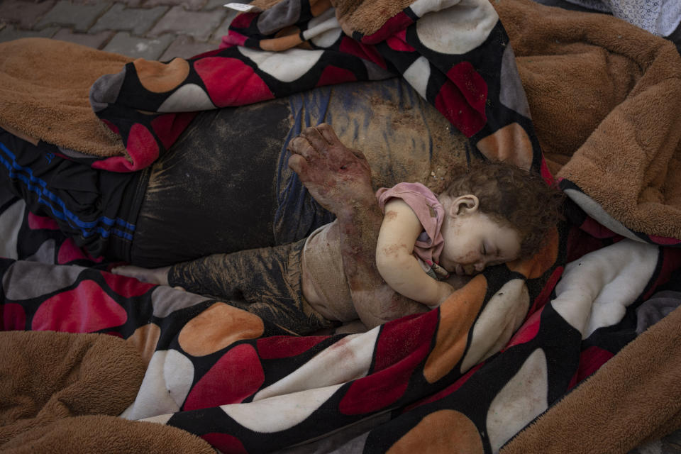 The bodies of a father and his child, killed in the Israeli bombardment of the Gaza Strip, lie in front of the morgue at Al-Aqsa Hospital in Deir Al-Balah, Sunday, Oct. 22, 2023. ( AP Photo/Fatima Shbair)