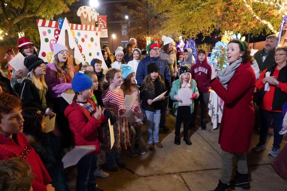 Leah Durham of the Alabama Choir School leads Christmas carols during the opening night of the Tinsel Trail in Government Plaza in Tuscaloosa Monday, Nov. 27, 2023. The ACS will join the TSO and others Monday in "Home for the Holidays."