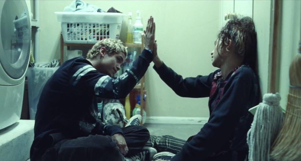 Dominic Fike and Zendaya high-fiving on season two, episode one of "Euphoria."