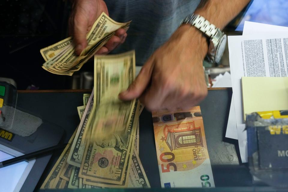A cashier changes a 50 Euro banknote with U.S. dollars at an exchange counter in Rome on July 13, 2022. Inflation for the European countries using the euro currency hit another record in August, fueled by soaring energy prices mainly driven by Russia’s war in Ukraine. Annual inflation in the eurozone’s 19 countries rose to 9.1% in August, up from 8.9% recorded in July.