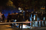 Israeli police crime scene investigators work at the scene of a shooting attack that wounded several Israelis near the Old City of Jerusalem, early Sunday, Aug. 14, 2022. Israeli police and medics say a gunman opened fire at a bus in a suspected Palestinian attack that came a week after violence flared up between Israel and militants in Gaza. (AP Photo/Maya Alleruzzo)