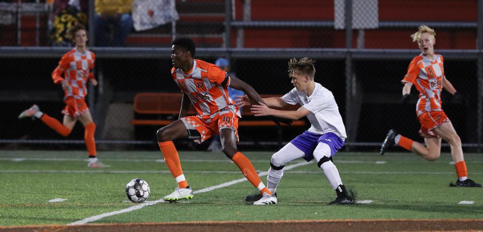 DeSales' Demba Jawo, left, battles Bardstown's Brogan Lyvers for possession during the first round of the state tournament Monday night. The Colts won, 3-0.