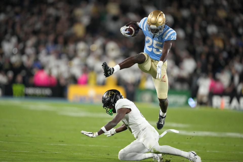 UCLA running back TJ Harden (25) hurdles Colorado cornerback Omarion Cooper (3) in the second half at Rose Bowl during the Bruins'  28-16 win.