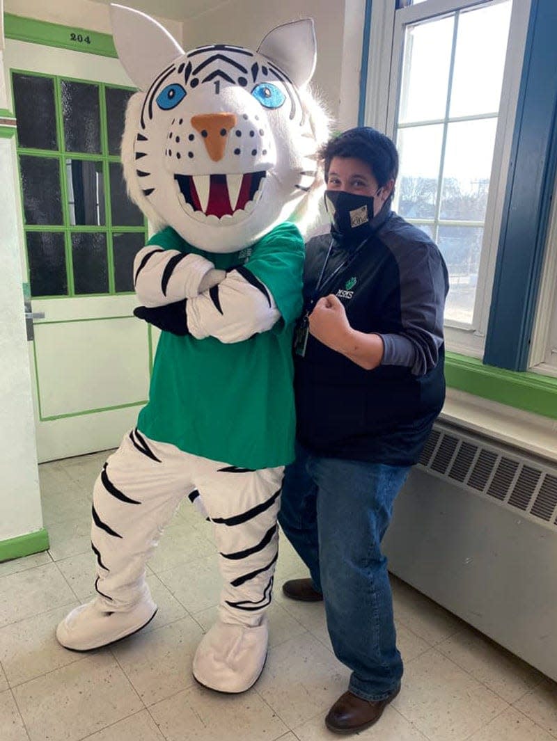 Dr. Erin Mahoney, principal of the Maple Street Magnet School, spreads school spirit with the school's mascot, Rocky the White Tiger.