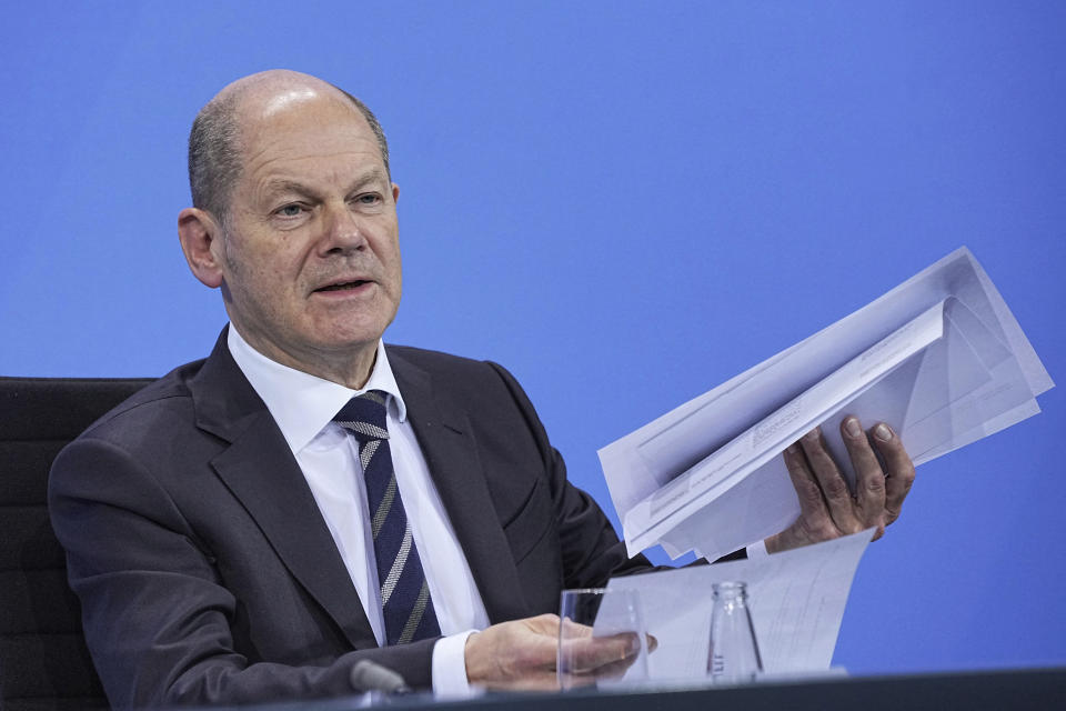 German Finance Minister, Olaf Scholz, meets the media in Berlin, Thursday, Nov. 18, 2021. German lawmakers have approved new measures to rein in record coronavirus infections after the head of Germany’s disease control agency warned the country could face a “really terrible Christmas.” The measures passed in the Bundestag on Thursday includes requirements for employees to prove they are vaccinated, recovered from COVID-19 or have tested negative for the virus in order to access communal workplaces. (Michael Kappeler, Pool via AP)