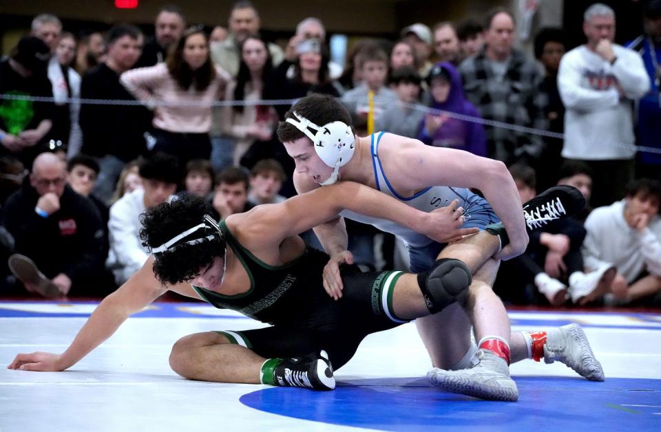 Scituate's Gabriel Bouyssou gets the upper hand on Ponaganset opponent Carnell Davis during the 150-pound championship match in early March.