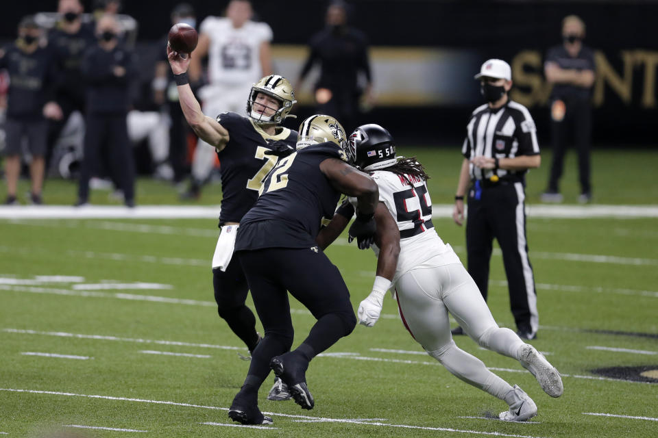 New Orleans Saints quarterback Taysom Hill (7) passes under pressure from Atlanta Falcons defensive end Steven Means (55)in the first half of an NFL football game in New Orleans, Sunday, Nov. 22, 2020. (AP Photo/Brett Duke)