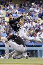 Colorado Rockies second baseman Ryan McMahon, top, attempts to throw out Los Angeles Dodgers' Chris Taylor at first as starting pitcher Kyle Freeland watches during the first inning of a baseball game Saturday, July 24, 2021, in Los Angeles. Taylor was safe at first on the play. (AP Photo/Mark J. Terrill)