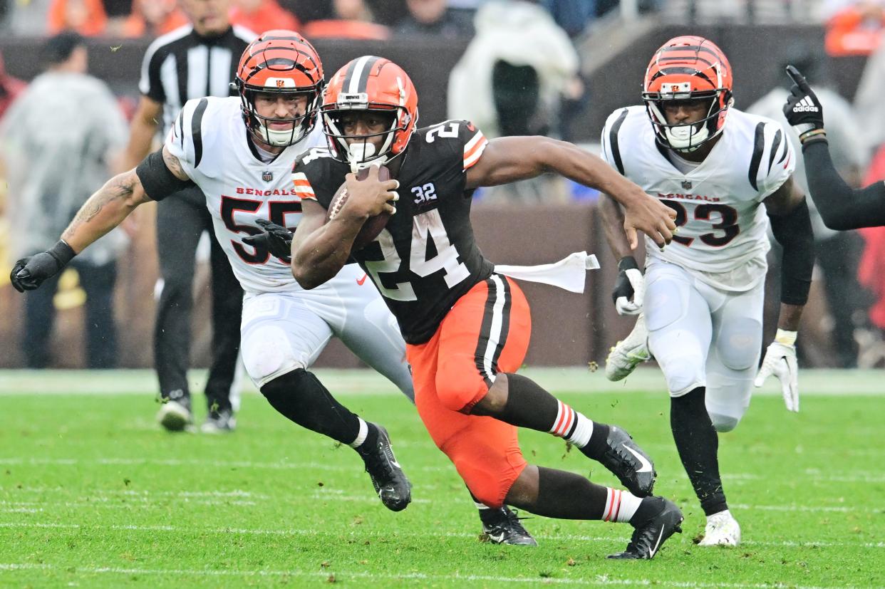 Sep 10, 2023; Cleveland, Ohio, USA; Cleveland Browns running back Nick Chubb (24) runs with the ball as Cincinnati Bengals linebacker Logan Wilson (55) and safety Dax Hill (23) defend during the first half at Cleveland Browns Stadium. Mandatory Credit: Ken Blaze-USA TODAY Sports