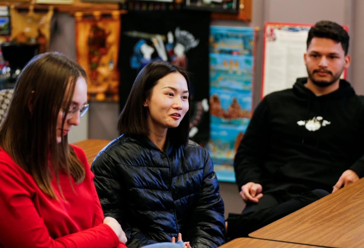 Ozarks Technical Community College English as a Second Language (ESL) student Shan He of China (center) talks about having a traditional Thanksgiving meal in Graff Hall with instructor Fran Giglio and other students.
