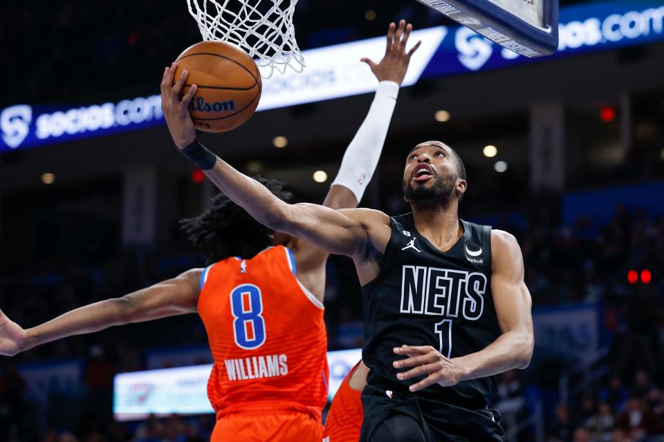 Brooklyn Nets forward Mikal Bridges (1) drives to the basket around Oklahoma City Thunder forward Jalen Williams (8) during the second quarter at Paycom Center in Oklahoma City on March 14, 2023.