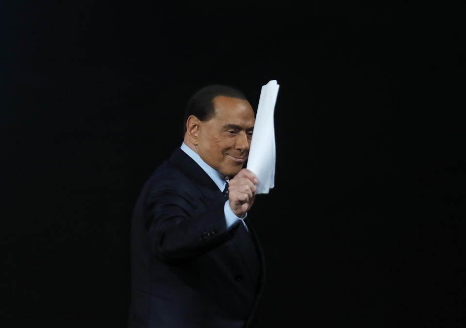 FILE - Italian former premier Silvio Berlusconi waves at the end of the Italian State RAI TV program "Che Tempo che Fa", in Milan, Italy, Sunday, Nov. 26, 2017. Berlusconi, the boastful billionaire media mogul who was Italy's longest-serving premier despite scandals over his sex-fueled parties and allegations of corruption, died, according to Italian media. He was 86. (AP Photo/Antonio Calanni, File)