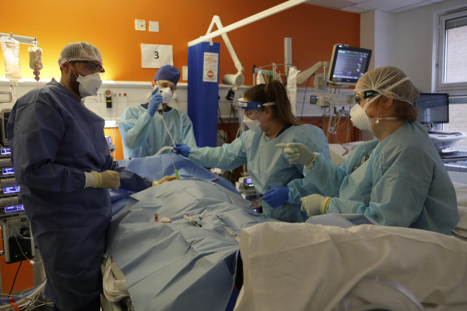 Critical Care Consultant Jenny Townsend, right, works with Critical Care staff to carry out a tracheostomy procedure on a COVID-19 patient on the Christine Brown ward at King's College Hospital in London, Wednesday, Jan. 27, 2021. (AP Photo/Kirsty Wigglesworth, Pool)