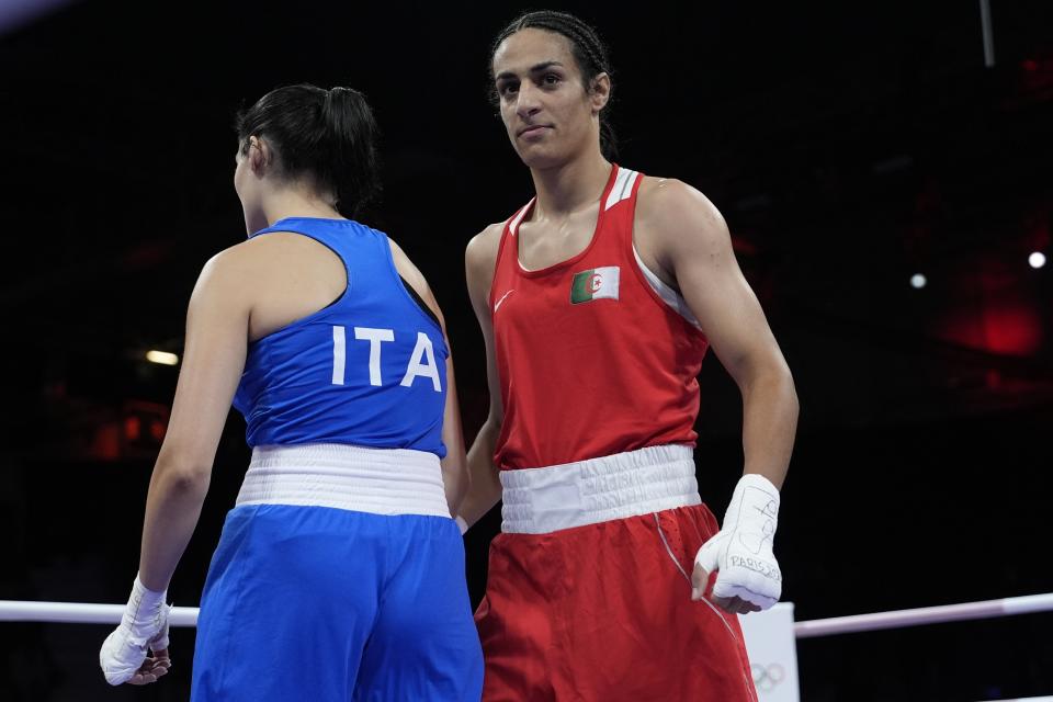 Imane Khelif dari Aljazair, kanan, setelah mengalahkan Angela Carini dari Italia, kiri, dalam pertandingan pendahuluan tinju putri kelas 66 kg di Olimpiade Musim Panas 2024, Kamis, 1 Agustus 2024, di Paris, Prancis. (Foto AP/John Locher)