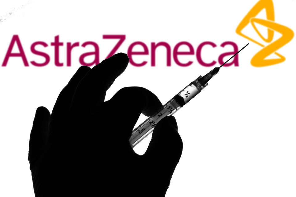 In this photo illustration the medical syringe is seen with AstraZeneca company logo displayed on a screen in the background. (Photo Illustration by Rafael Henrique/SOPA Images/LightRocket via Getty Images)