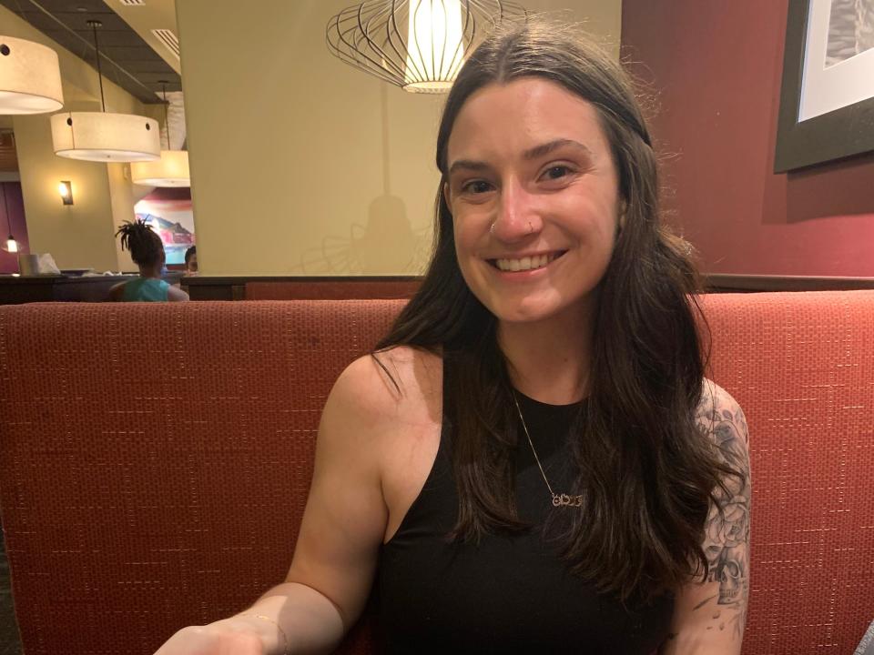 The author smiles with a piece of cake at Olive Garden.