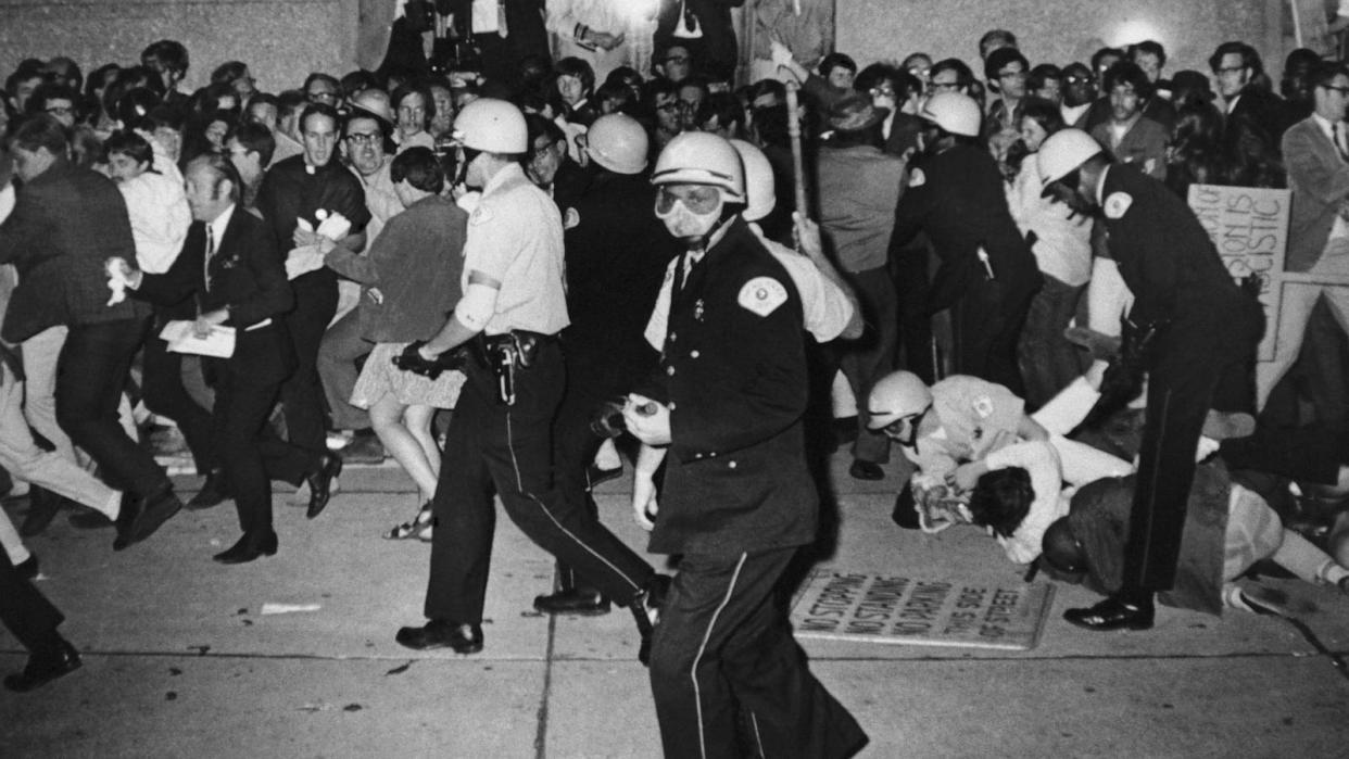 PHOTO: In this Aug. 29, 1968 file photo, Chicago police officers attempt to disperse demonstrators outside the Conrad Hilton, Democratic Convention headquarters hotel in Chicago.     (Michael Boyer/AP, FILE)